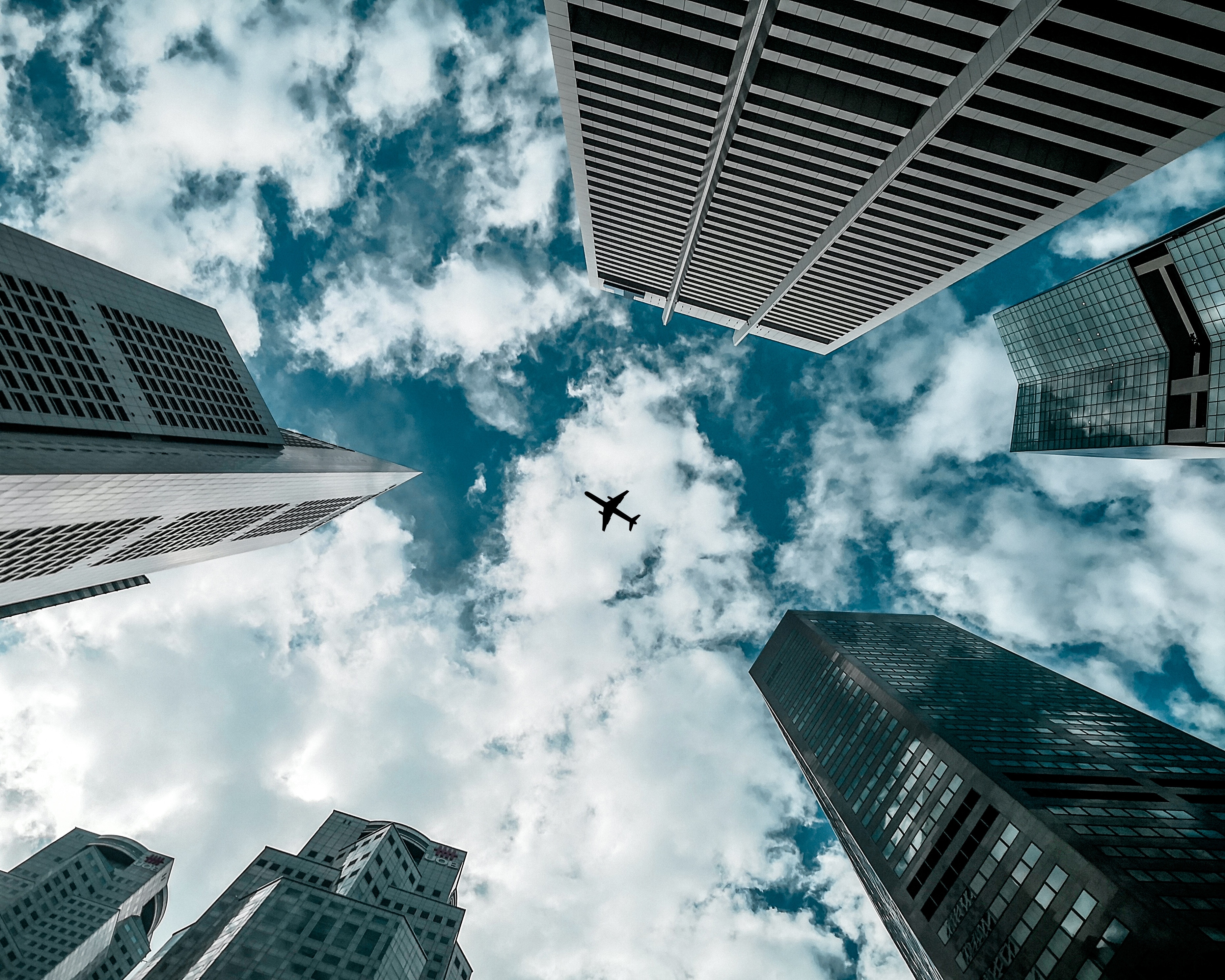 Buildings and Airplane in Sky